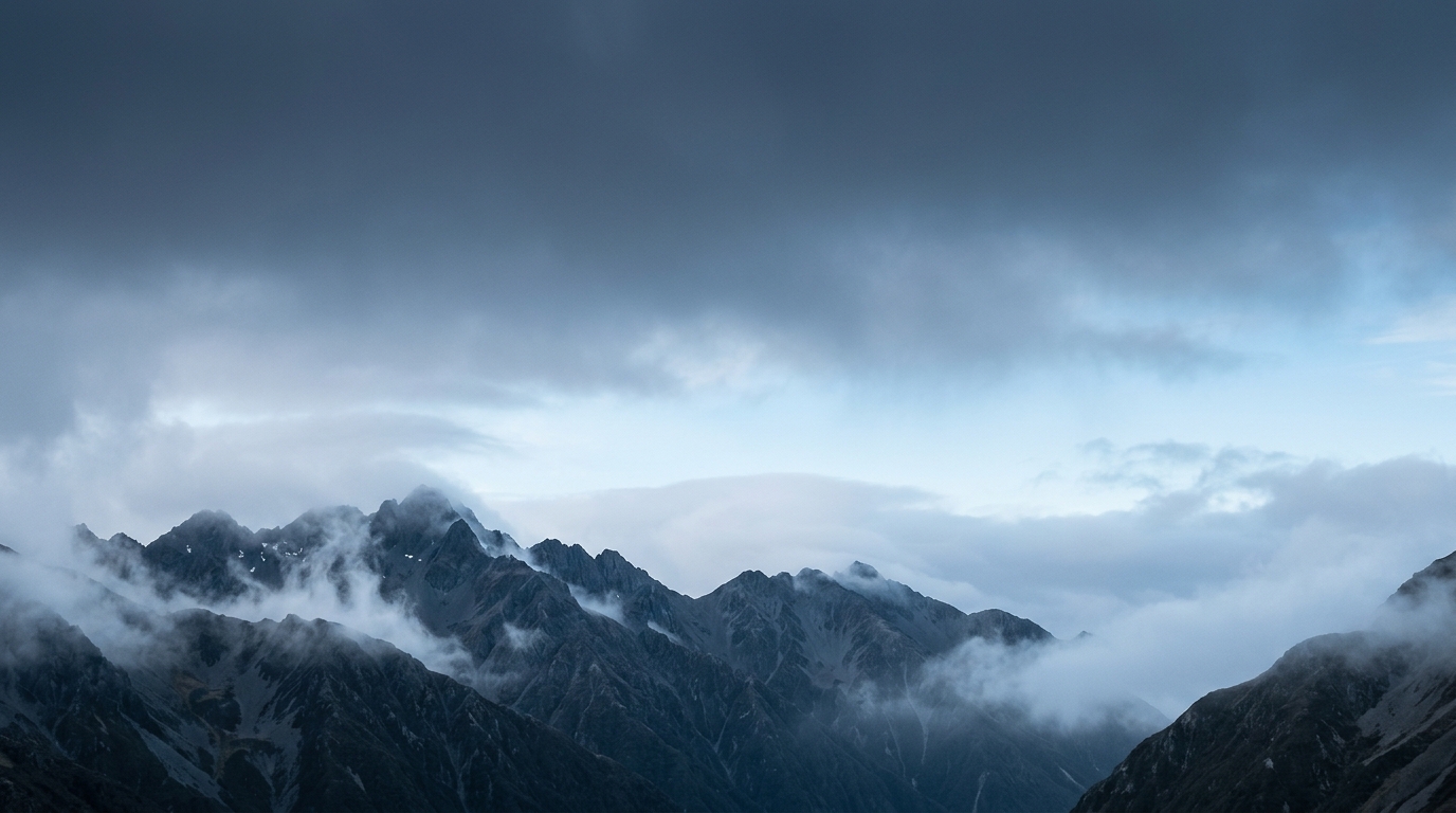 New Zealand alpine ridgeline emerging through morning cloud